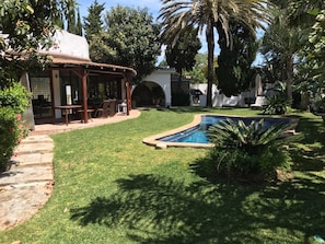 Terrace in background next to pool 