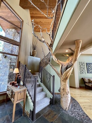 A giant real tree supporting the stairs to game area.