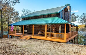 Full wrap around porch with porch swings - and the US Flag - invite you in.  