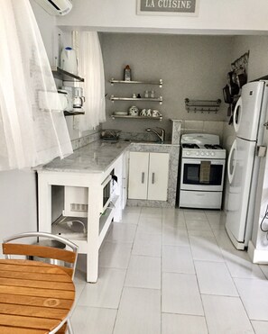 Marble countertops, stove, fridge, microwave, coffee maker, ice maker, toaster..