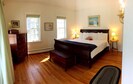 Primary bedroom, first floor, King bed with attached bathroom and porch.