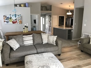 Living Room with 2 couches, Large Flat Screen TV & new hardwood floors!
