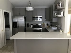 Newly renovated Kitchen with Stainless appliances and large quartz countertops
