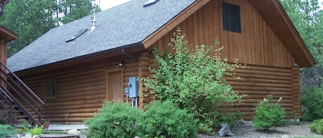 Outside of garage with apartment in upper floor.