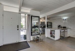 Front entryway and view of kitchen.