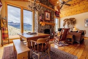 The open dining and living room with vaulted ceilings and windows to take in all the views