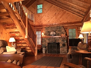 Living room, fireplace & log staircase
