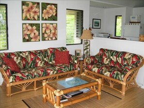 Tropical decor with original art, looking from living room into kitchen.