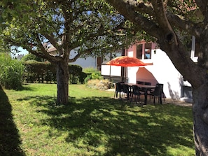 Large garden with shaded sitting area and barbecue area