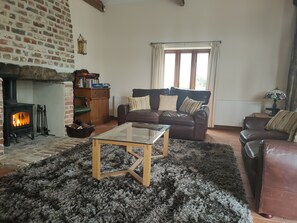 Relax in the cosy lounge area with wood burning stove.