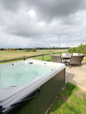 Rear garden,  optional hot tub and coal BBQ.   With closed in fence for dogs. 