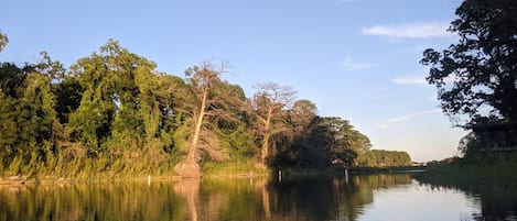 View of river from kayak at sundown