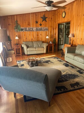 Cozy living room has a true lodge feel & plenty of comfy seating.