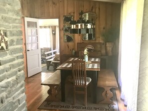 Dining table has 2 leaves for extra seating. It opens up to the closed in porch.