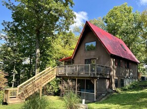 Rear side of cabin with new stairway leading down to fire pit