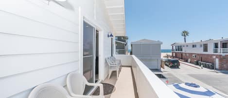 This bright and cheery upstairs unit is just what you need for a refreshing retreat. One house from the sand & a view of the ocean from your front balcony!