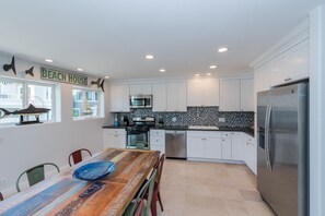 The kitchen opens out to the dining area, for easy group meals, game nights, you name it!
                