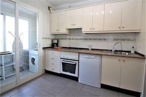 Fully equipped kitchen with all the appliances and laundry room to the rear