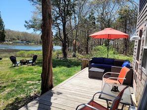 Big deck with comfortable furniture overlooking the pond.