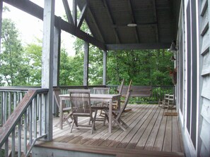 Back porch w/ long-range views, swing, rocking chairs, grill & outdoor dining.