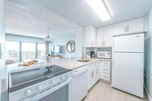 Fully equipped kitchen with sleek appliances and ample counter space.