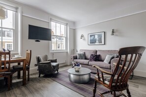 Seating area showing TV and lovely windows