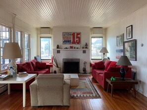 Living Room with window seats overlooking yard and beach.