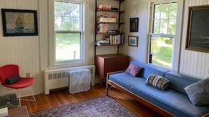 TV room with day bed on 1st floor.