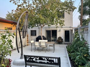 Your private outdoor patio with BBQ, oversized sunbrella and sitting benches.