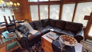 Large couch is placed in the living room for relaxation time.