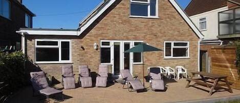 The rear patio with comfortable chairs, table & gas BBQ.