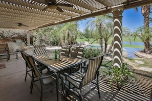 covered patio looks to pool, spa, double fairway, mountains and lake