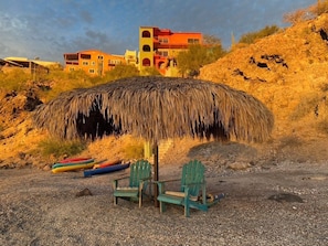 Shade from your palapa on your private beach. Your kayaks and Sups are there too