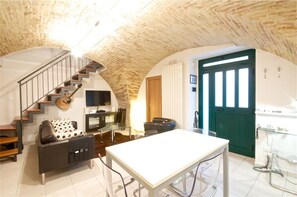 The vaulted brick ceiling & pillar is original to this century old property