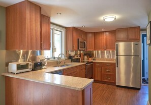Kitchen: quartz countertops, cherry cabinets, and stainless steel appliances.