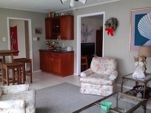 View of the sunroom with a wetbar.  Door to 5th bedroom is on the left.  