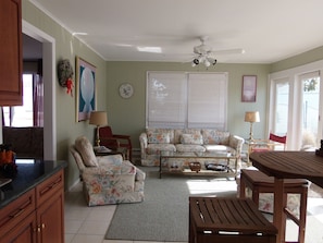 Sunroom looks out to pool. It has a wet bar and pub set.