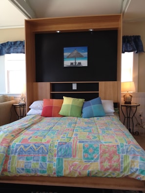 Comfy queen sized bed stores up into cabinet for added daytime living space
