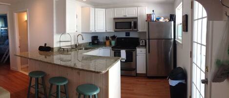 Kitchen with dishwasher and seating for 3 at the granite peninsula
