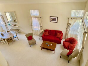 The living room is full of natural light and adjacent to the dining room.