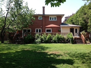 Back of house with large deck and private backyard