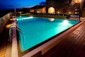 The very large swimmingpool, here seen during night, is a great relaxing place