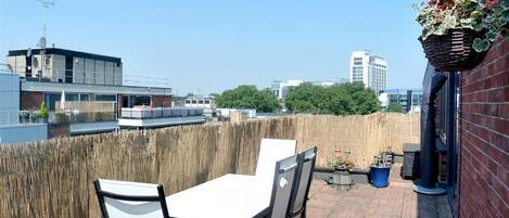 Sunny terrace with furniture and views to London Eye