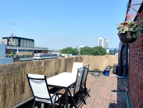 Sunny terrace with furniture and views to London Eye