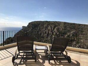 Relaxing loungers on the south facing terrace with sea and mountain views