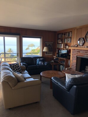 Main living room with fireplace and view of the Pacific
