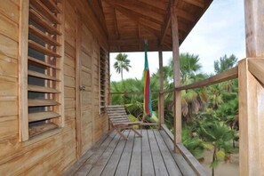 Deck with seating and hammock overlooking Caribbean.