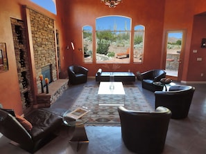 Desert and mountain views from living room + double height ceilings & fireplace