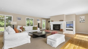 living area with gas fire leads onto the deck