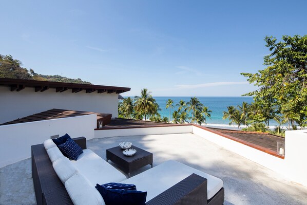 rooftop lounge with view of the beach and gulf